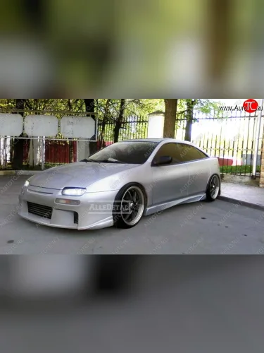 Передний бампер Next Mazda 323 BA дорестайлинг седан (1994-1996)